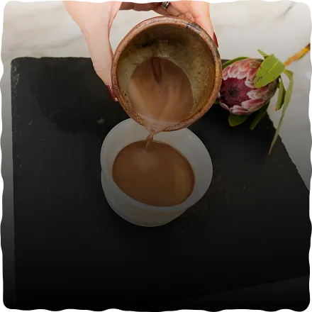 Pouring prepared ceremonial cacao into a cup